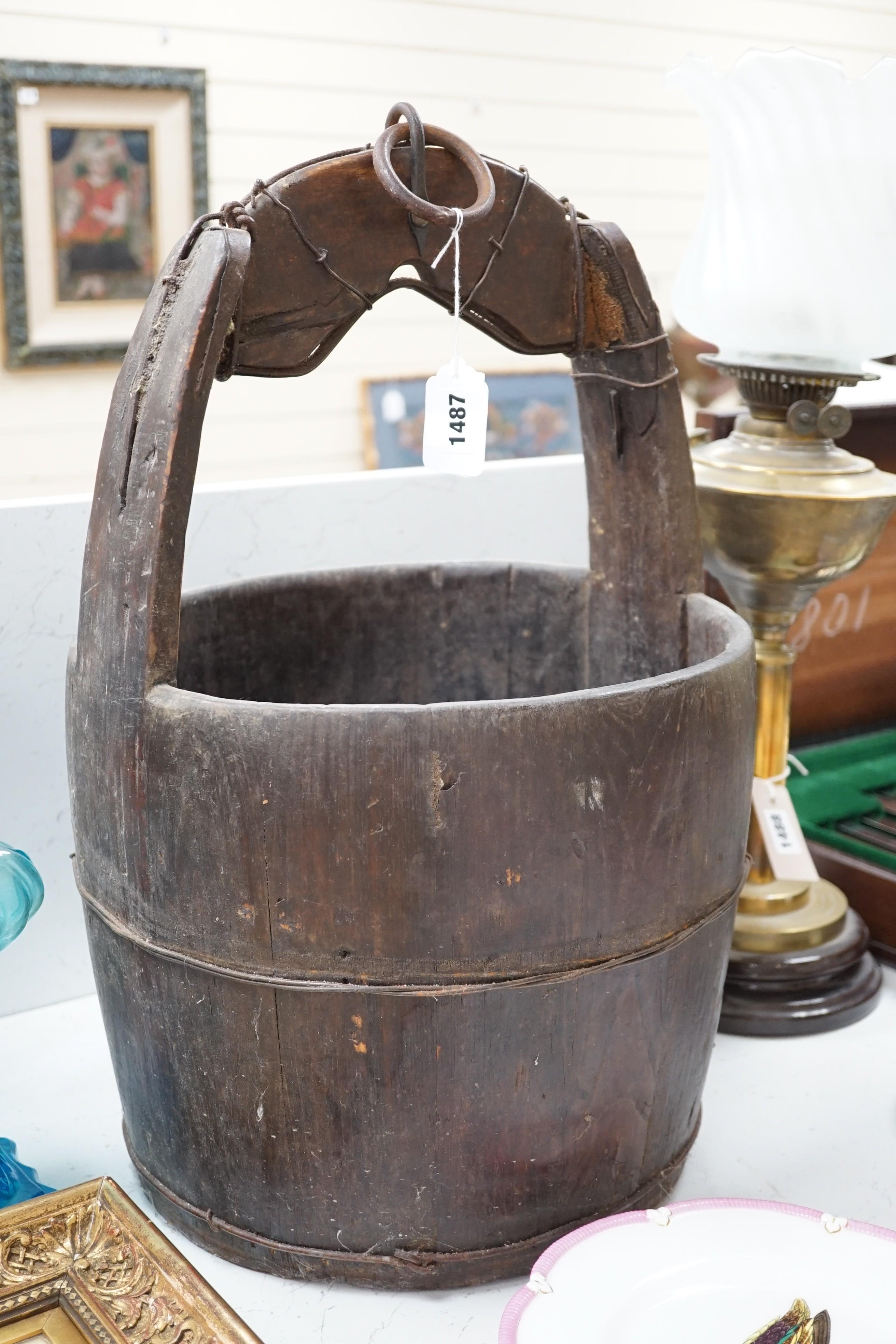 A Chinese bucket and pair of clogs, bucket 57cms high